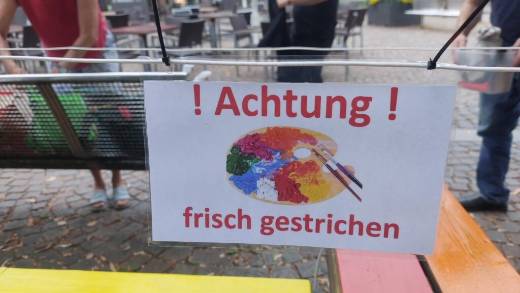 Foto von einer Bank mit Text "Frisch gestrichen"